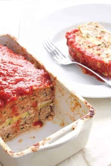 Layered Turkey Meatloaf with Roasted Red Pepper and Balsamic Glaze with pieces removed to expose filling.