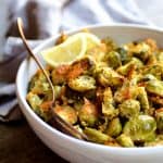 Lemon Parmesan Crusted Brussels Sprouts in white bowl with serving fork.