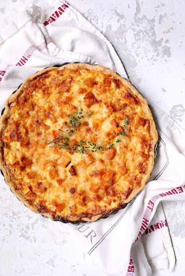 Whole Butternut Squash Leek and Gruyere Tart on French towel.