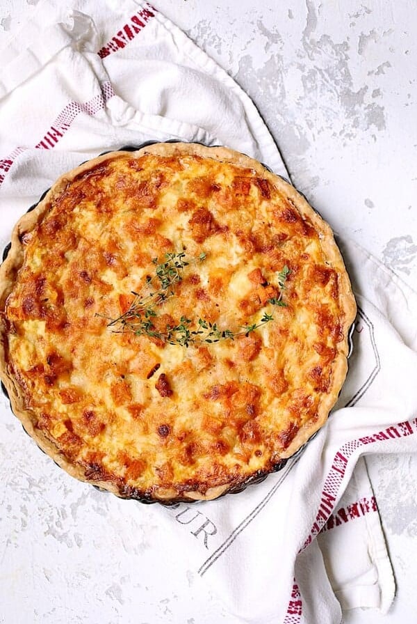 Whole Butternut Squash Leek and Gruyere Tart on French towel.