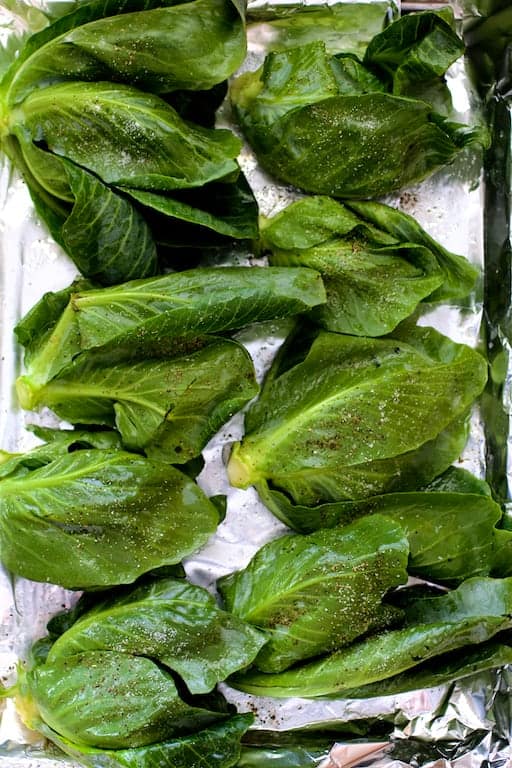 Photo of cabbage sprouts on baking sheet before being roasted.