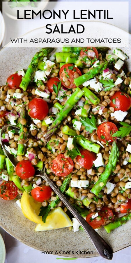 Pinterest graphic for Lemony Lentil Salad with Asparagus and Tomatoes showing it in an earthenware bowl with serving spoon.
