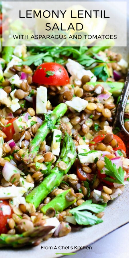 Pinterest graphic for Lemony Lentil Salad with Asparagus and Tomatoes showing it in an earthenware bowl with serving spoon.
