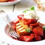 Grilled Pound Cake with Balsamic Mascerated Strawberries and Mascarpone Cream on white plate with fork.