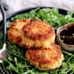 Tuna Kimchi Cakes with Soy Ginger Dipping Sauce - Close-up hero shot of cakes on plate with arugula and dipping sauce