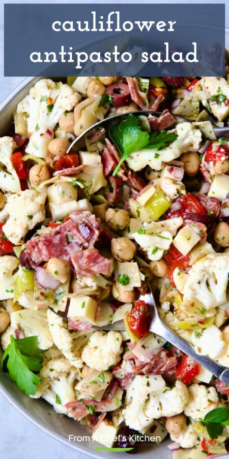 Pinterest graphic for Cauliflower Antipasto Salad in bowl with serving utensils.