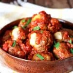 Pepperjack-Stuffed Meatballs with Chipotle Sauce in earthenware serving bowl.