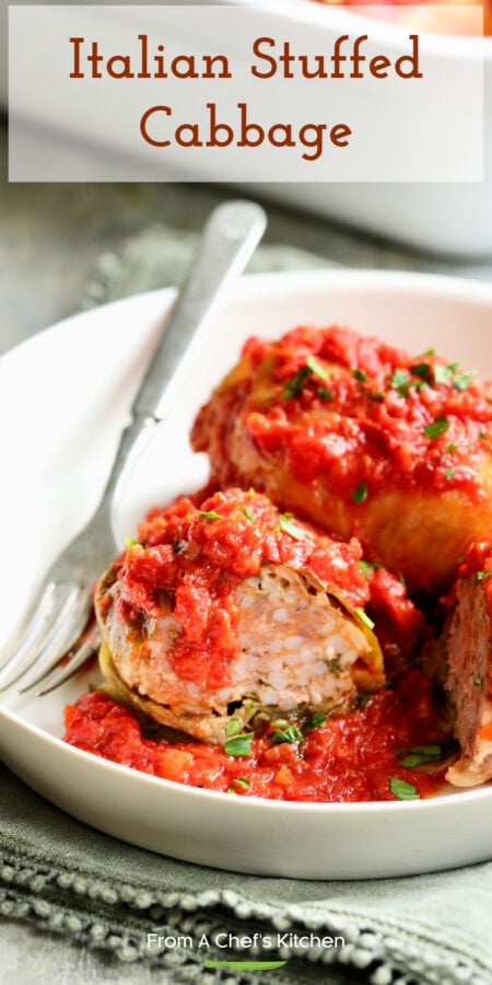 Pinterest graphic for Italian Stuffed Cabbage showing a roll cut in half to expose filling on a white plate.