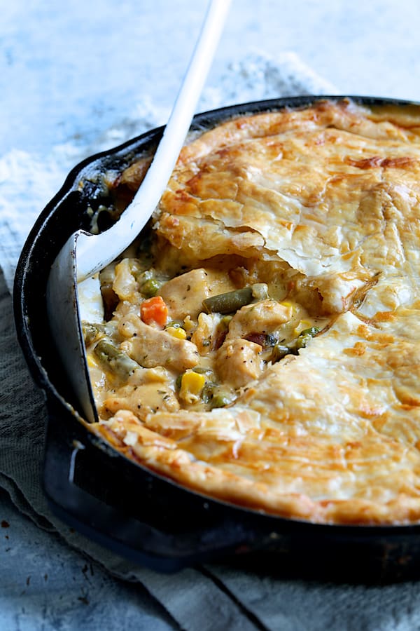 Close-up photo of Cheesy Skillet Chicken Pot Pie in cast iron skillet showing the filling.