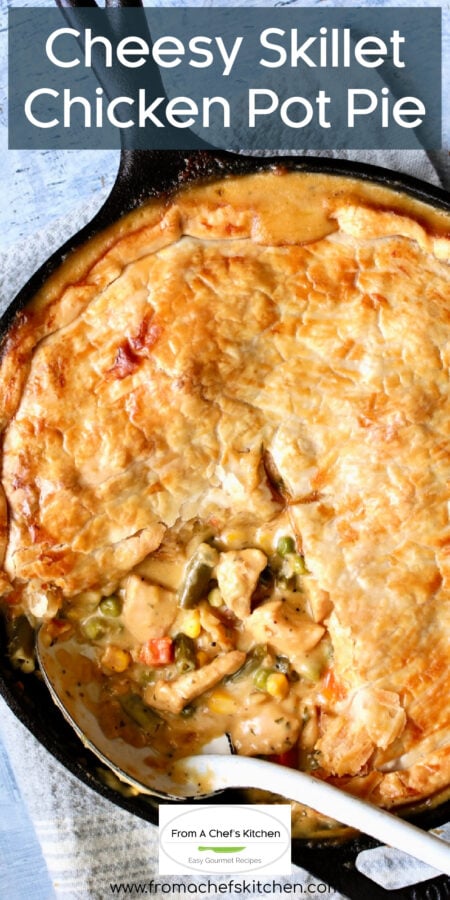 Pinterest graphic for Cheesy Skillet Chicken Pot Pie showing it with a piece removed in black cast iron skillet.
