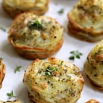 Garlic Herb Muffin Pan Potato Galettes - Straight-on hero shot on white background garnished with fresh thyme