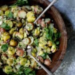 French-Style Potato Salad - Overhead hero shot of salad in wood bowl with serving utensils