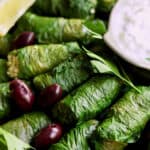 Close-up photo of Quinoa-Stuffed Swiss Chard Dolmas with Tzatziki.