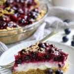 Photo of a slice of Blueberry Cream Cheese Pie on a white plate.