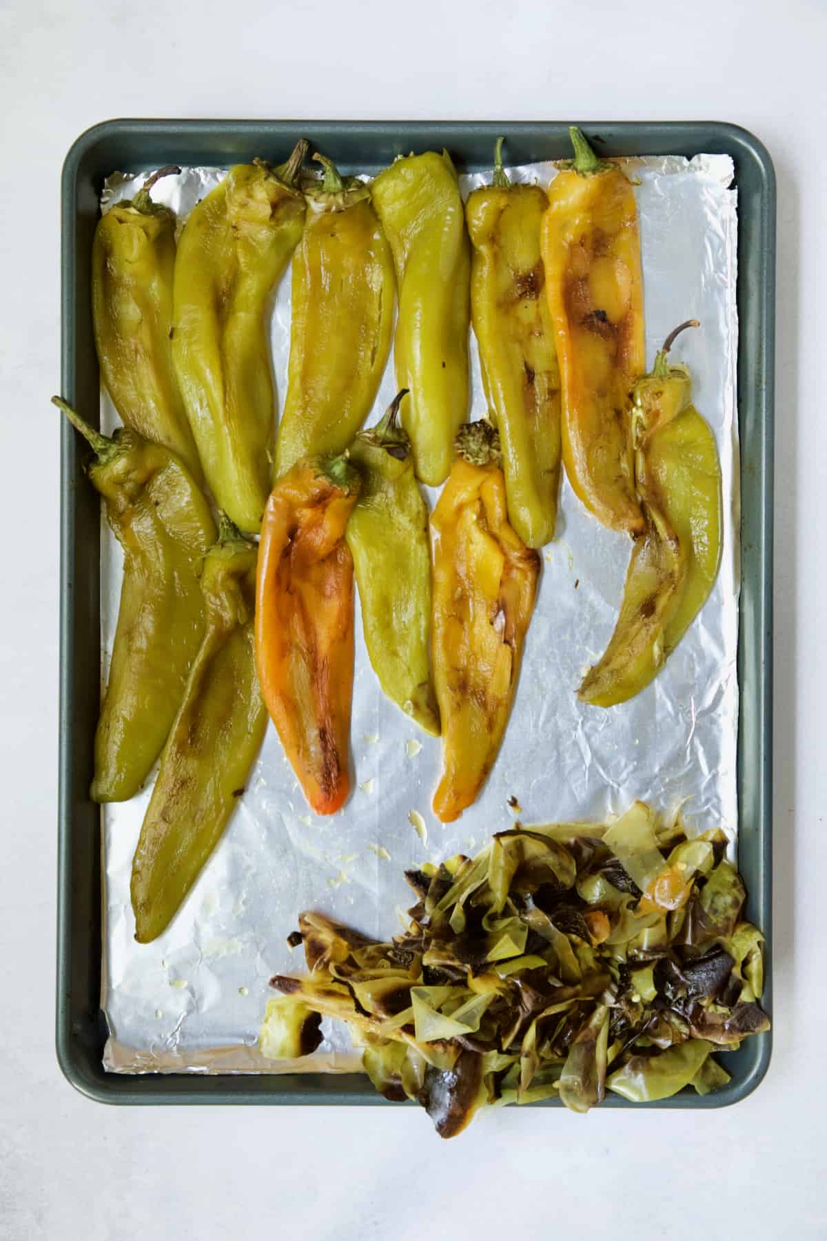 Roasted and peeled Hatch green chiles on rimmed baking sheet.