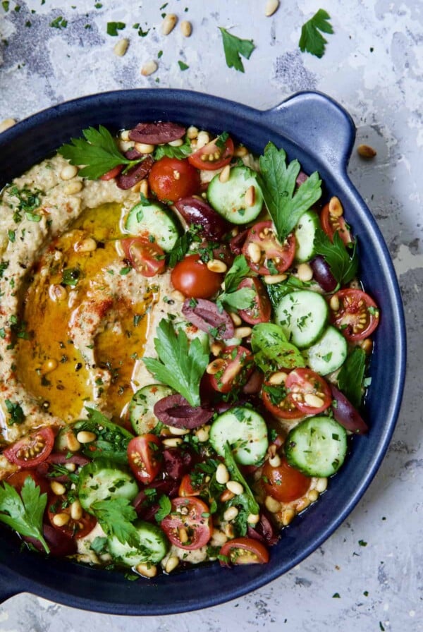 Loaded Roasted Eggplant Dip (Baba Ganoush) in blue dish.
