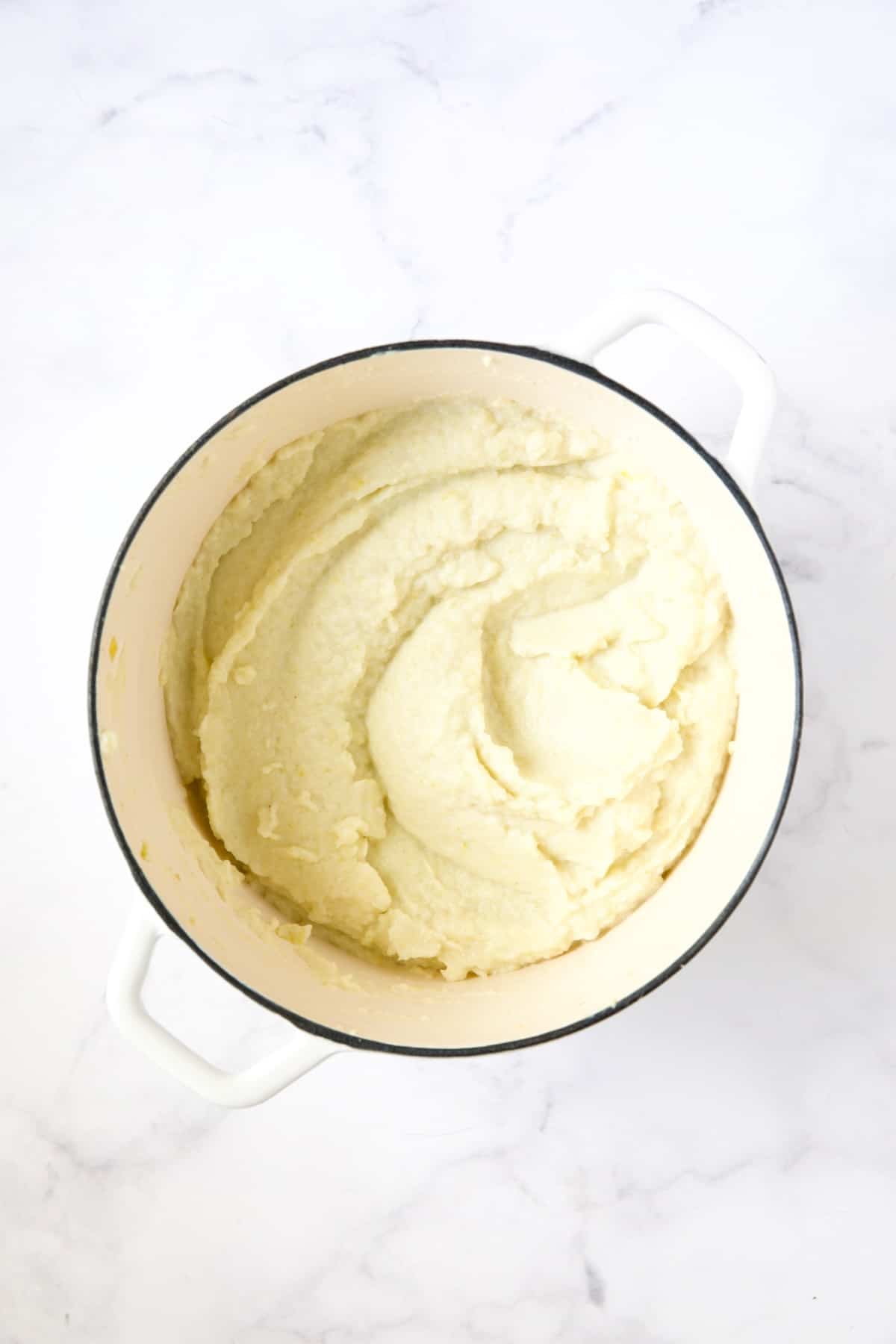 Cauliflower Leek Puree in white enamel Dutch oven.