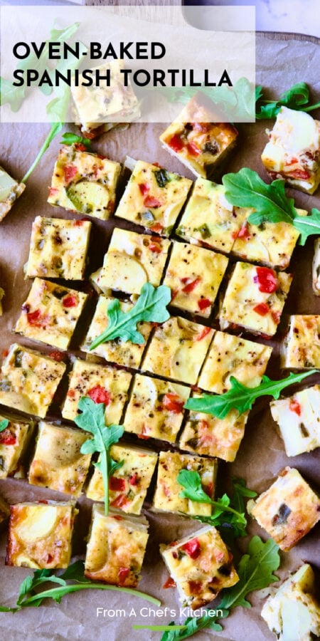 Pinterest graphic for Baked Spanish Tortilla showing it cut into small squares on wood cutting board.
