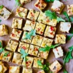 Oven-Baked Spanish Tortilla on cutting board garnished with arugula.