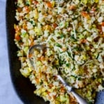 Garlic Parmesan Roasted Riced Vegetables on platter with serving spoon.