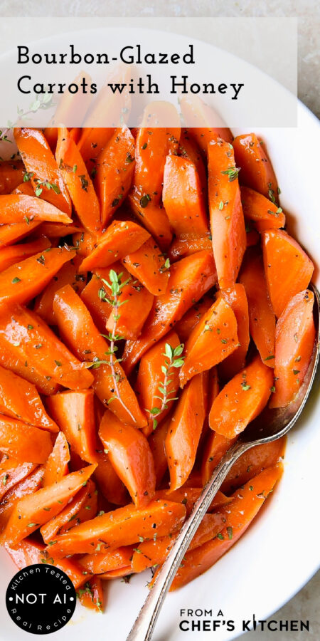 Pinterest graphic for Bourbon-Glazed Carrots with Honey showing them in an oval white serving bowl with serving spoon.