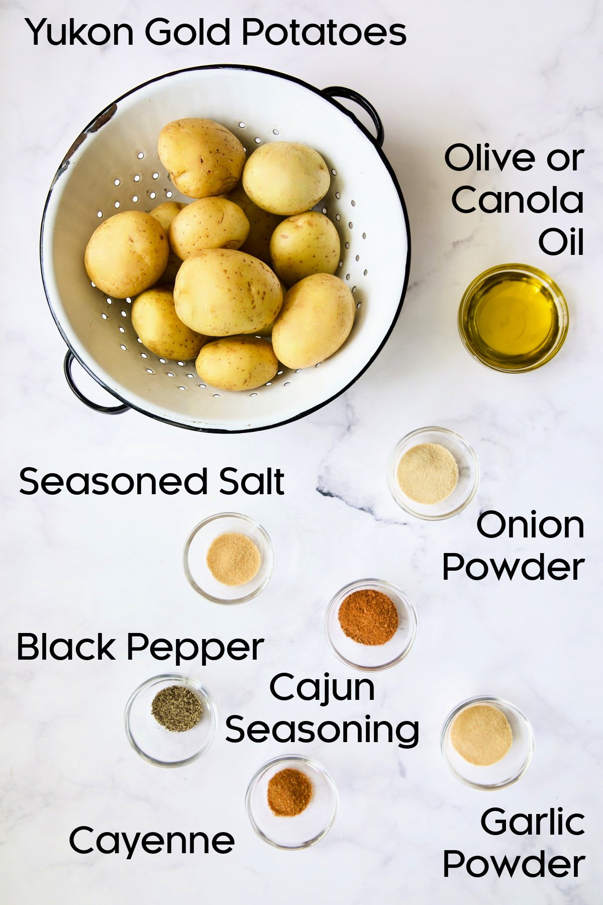 Ingredients for Perfect Roasted Potato Wedges on white marble background.