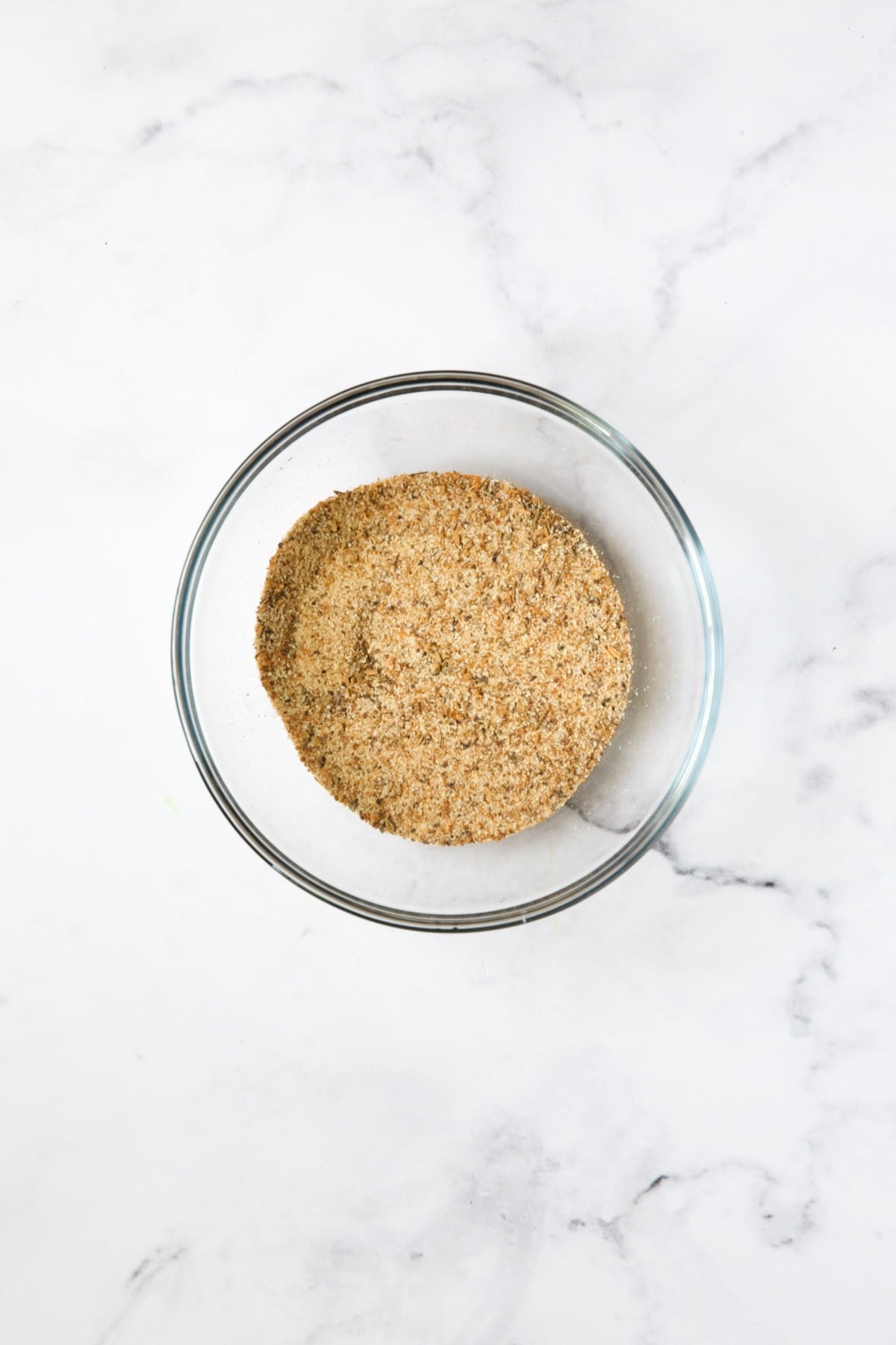 Seasoning blend for potato wedges in glass bowl.