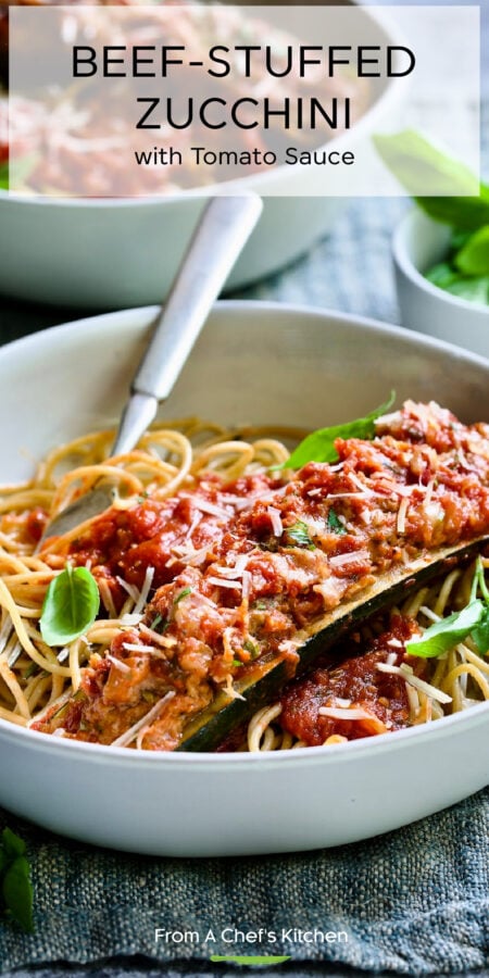 Pinterest graphic for Beef Stuffed Zucchini with Tomato sSauce showing one over pasta in a white bowl with fork.
