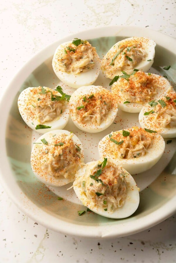 Crab Deviled Eggs on platter garnished with parsley.