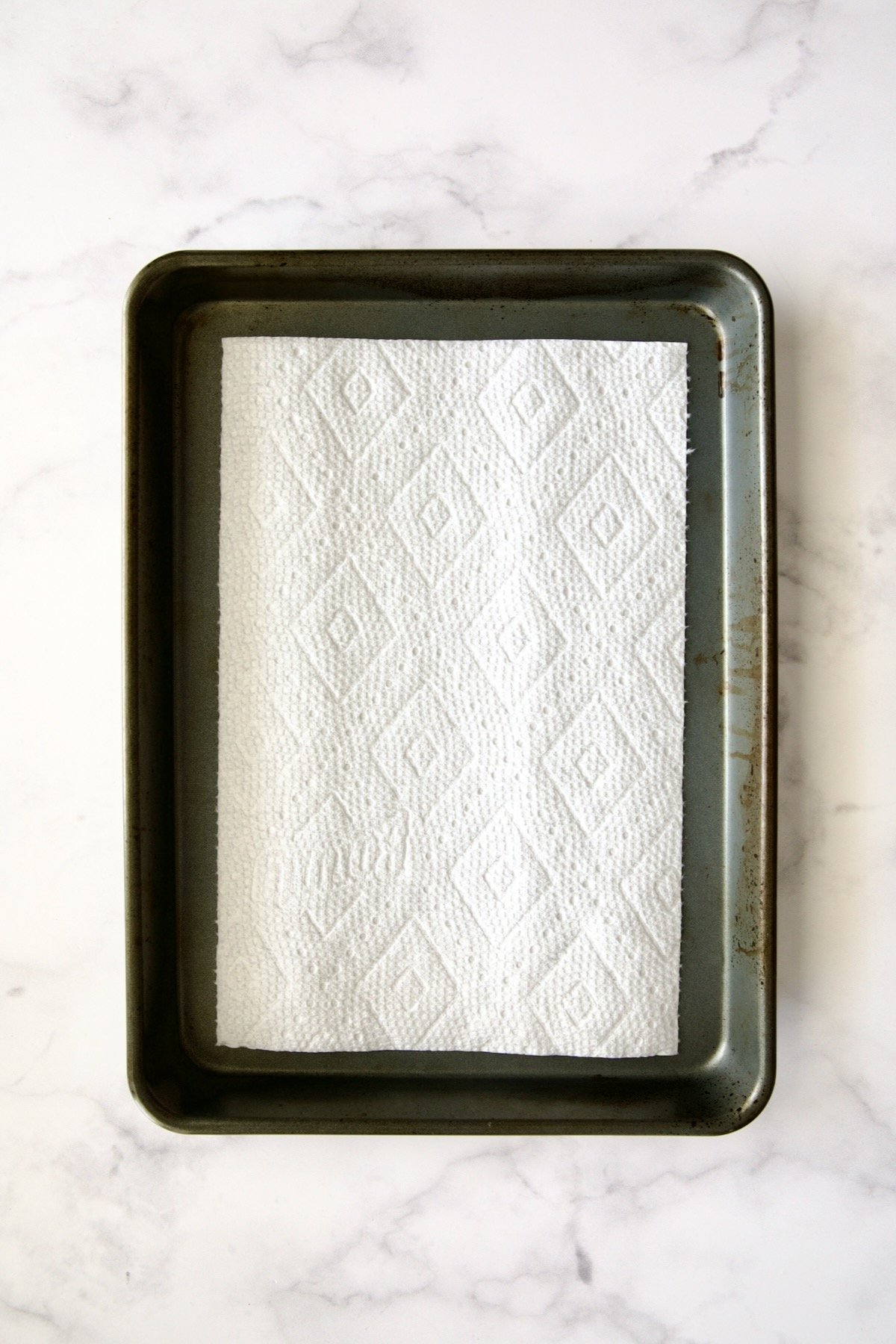 Dry piece of paper towel on rimmed sheet pan.