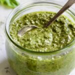 Jar of Pesto Genovese with spoon.