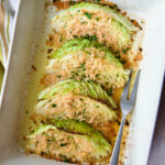 Baked Cabbage with Garlic and Parmesan in white baking dish with serving fork.