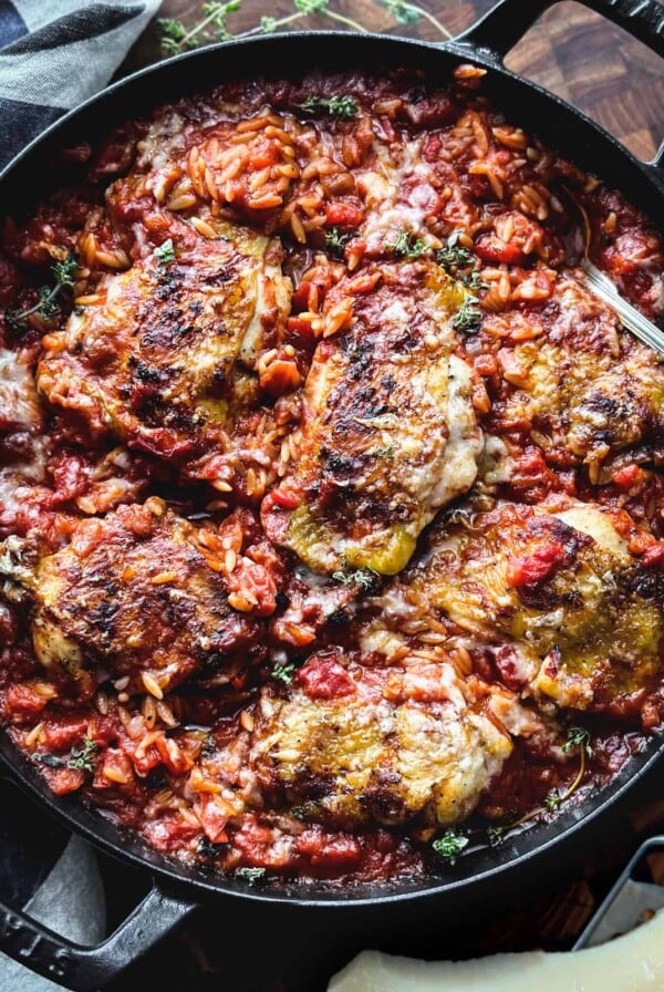 Greek Chicken Orzo in cast iron skillet.