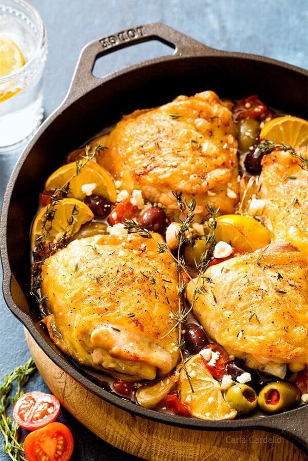 Four Mediterranean Chicken Thighs in cast iron skillet.