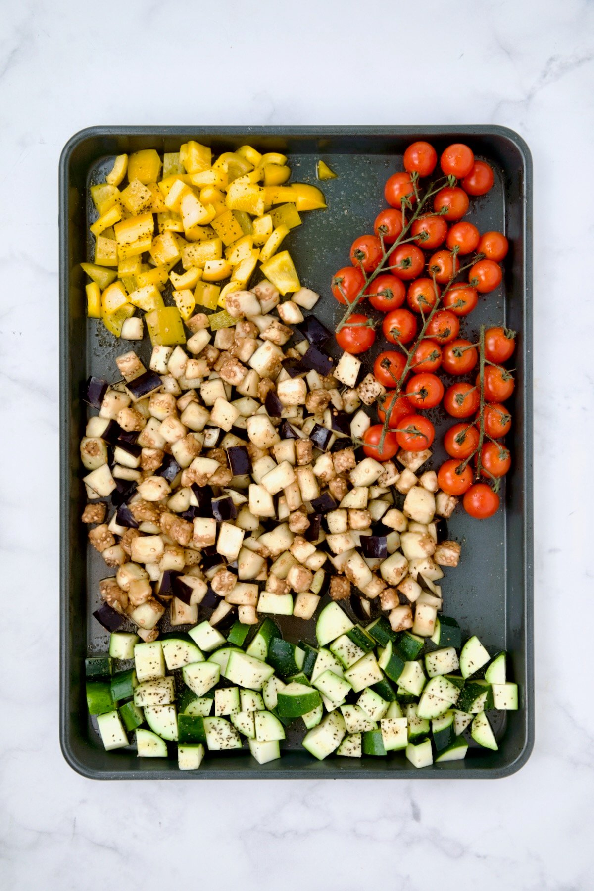 Vegetables for galette on rimmed sheet pan before being roasted.