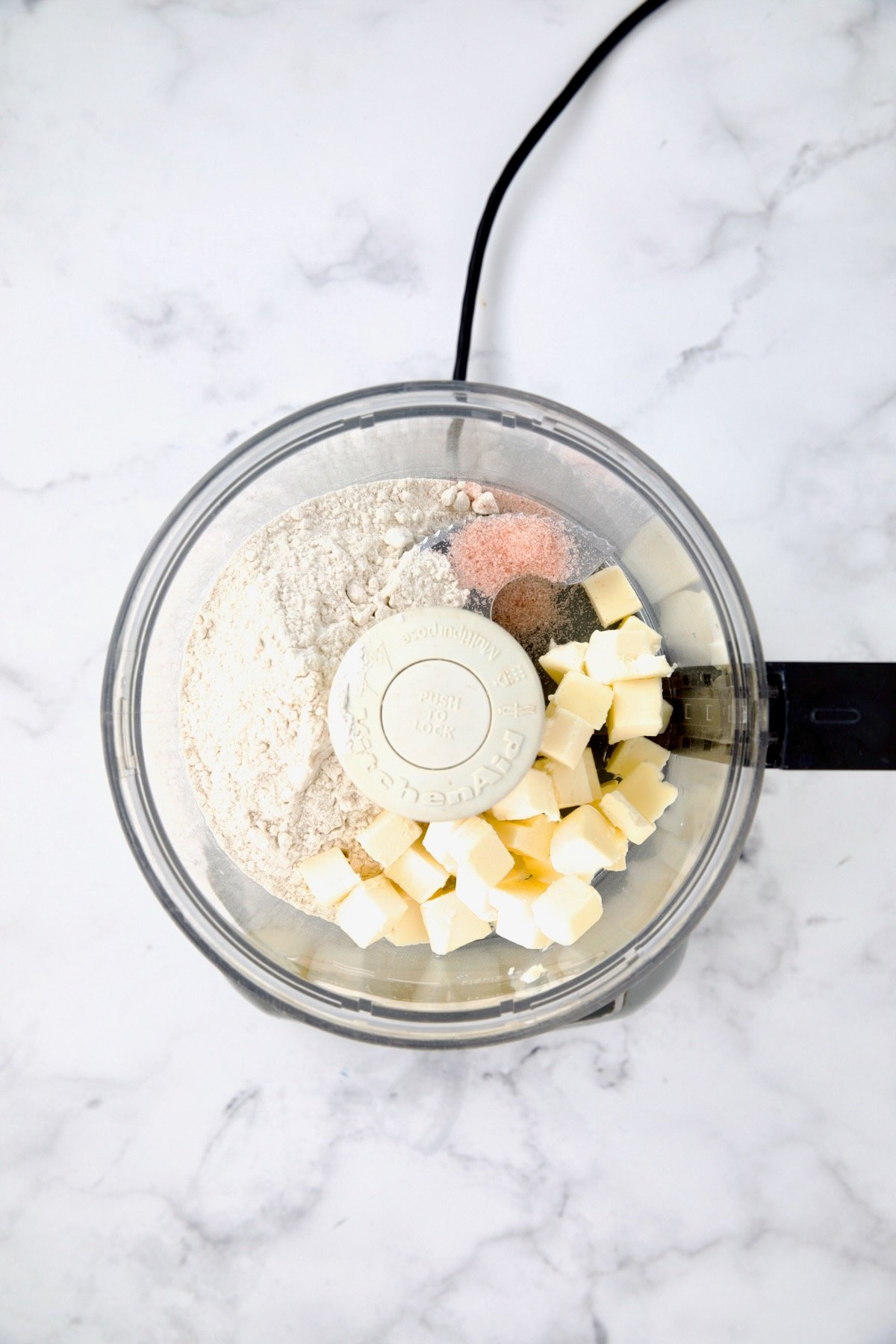 Ingredients for galette pastry in food processor before being combined.