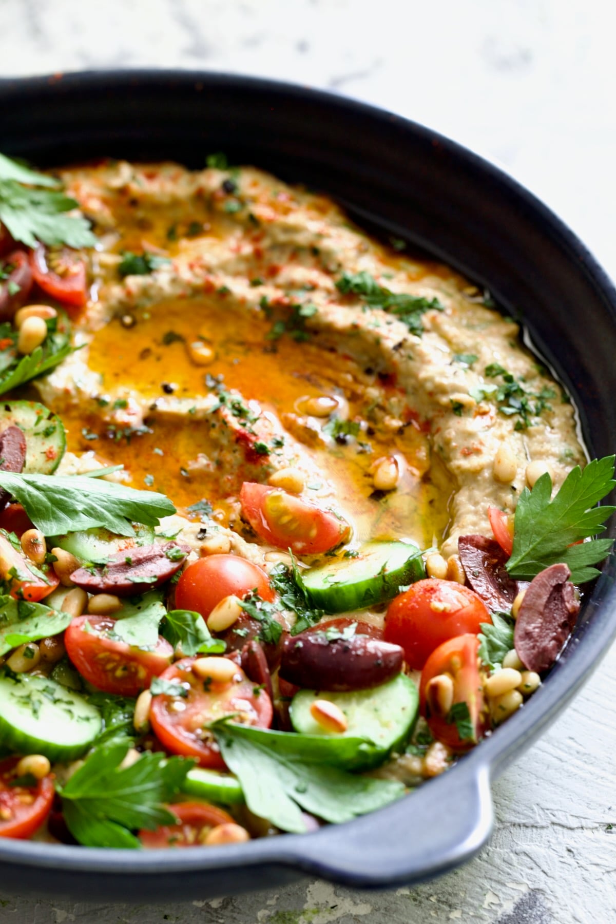 Loaded Roasted Eggplant Dip (Baba Ganoush) in blue dish.