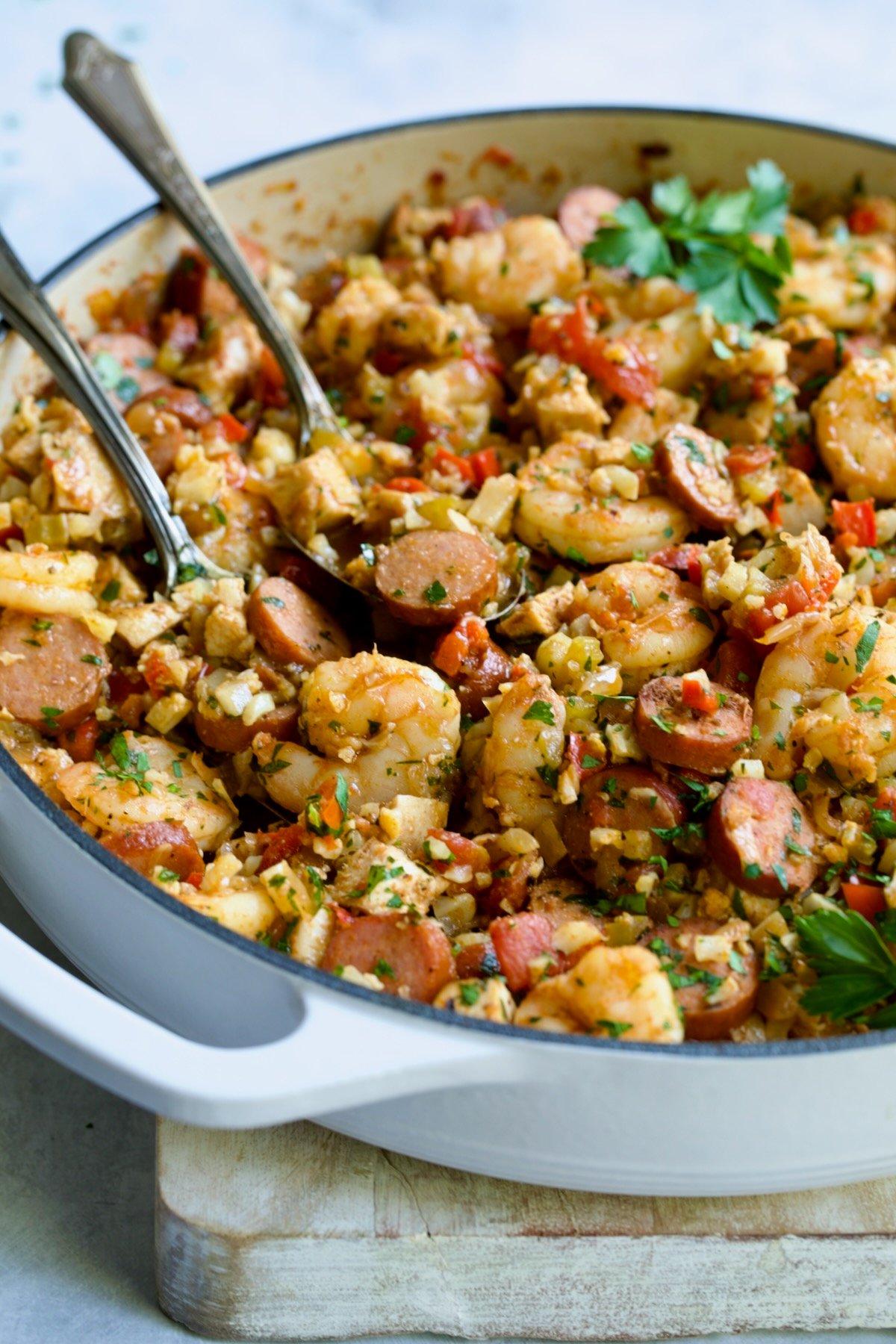 Low Carb Jambalaya with Chicken, Shrimp and Sausage in white enamel cast iron skillet.