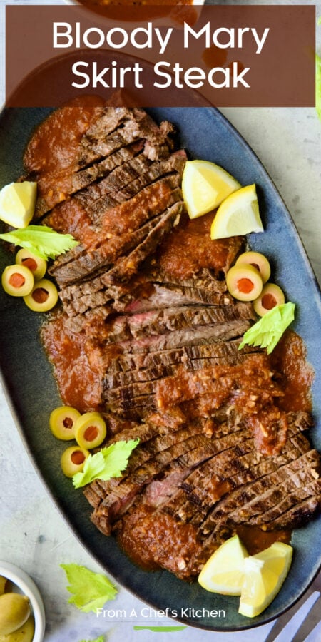 Pinterest graphic for Bloody Mary Skirt Steak showing it on a blue platter garnished with lemon wedges, celery leaves and sliced green olives.