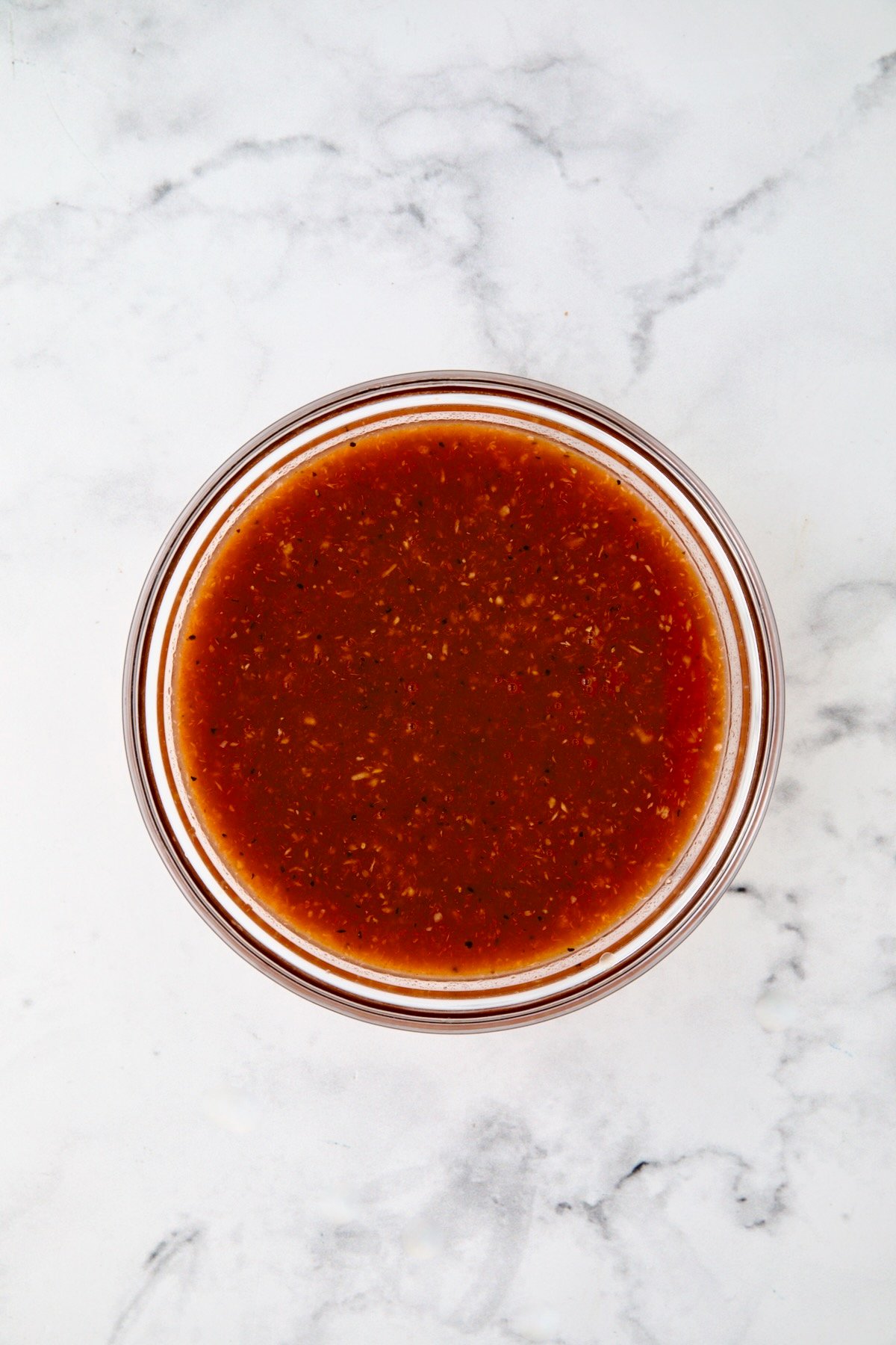 Bloody Mary marinade in glass bowl.