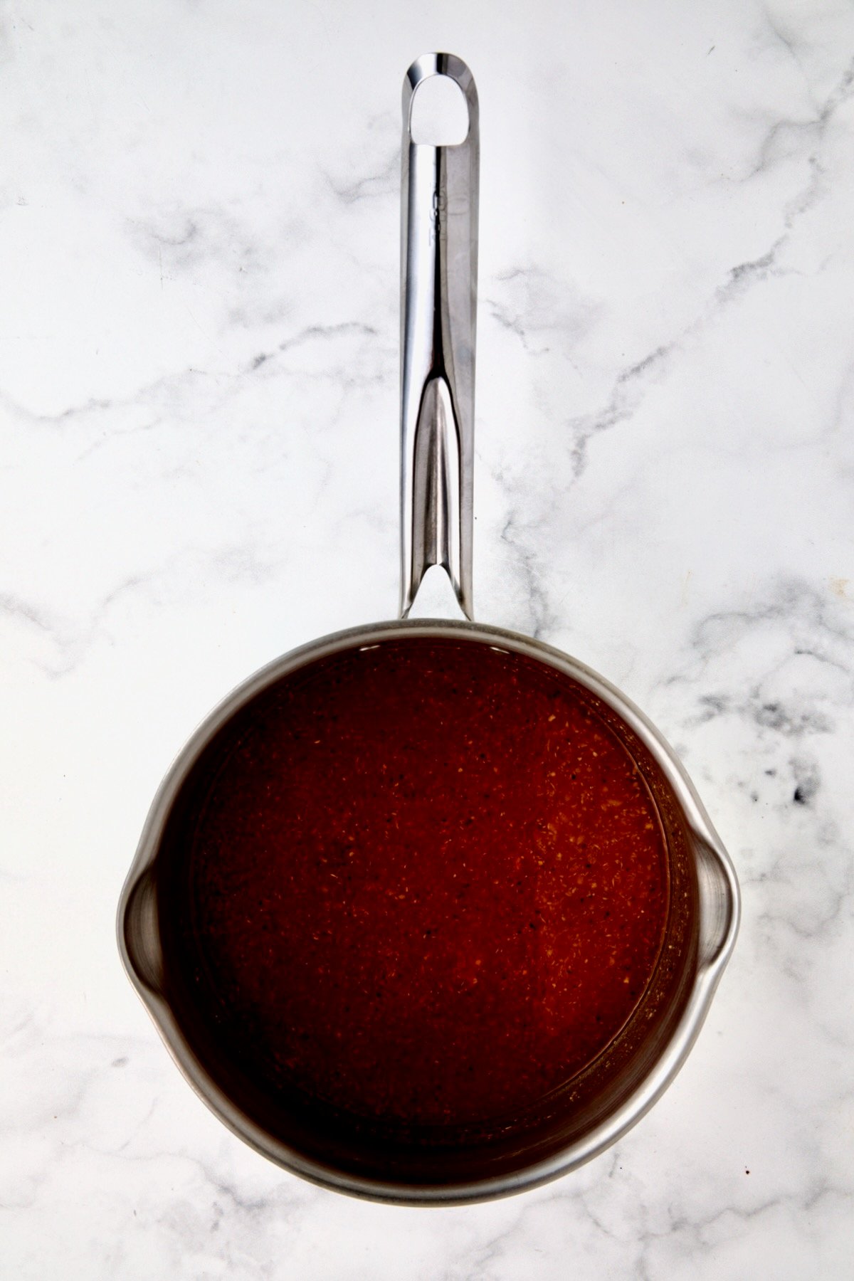 Bloody Mary marinade in stainless steel saucepan before being boiled.