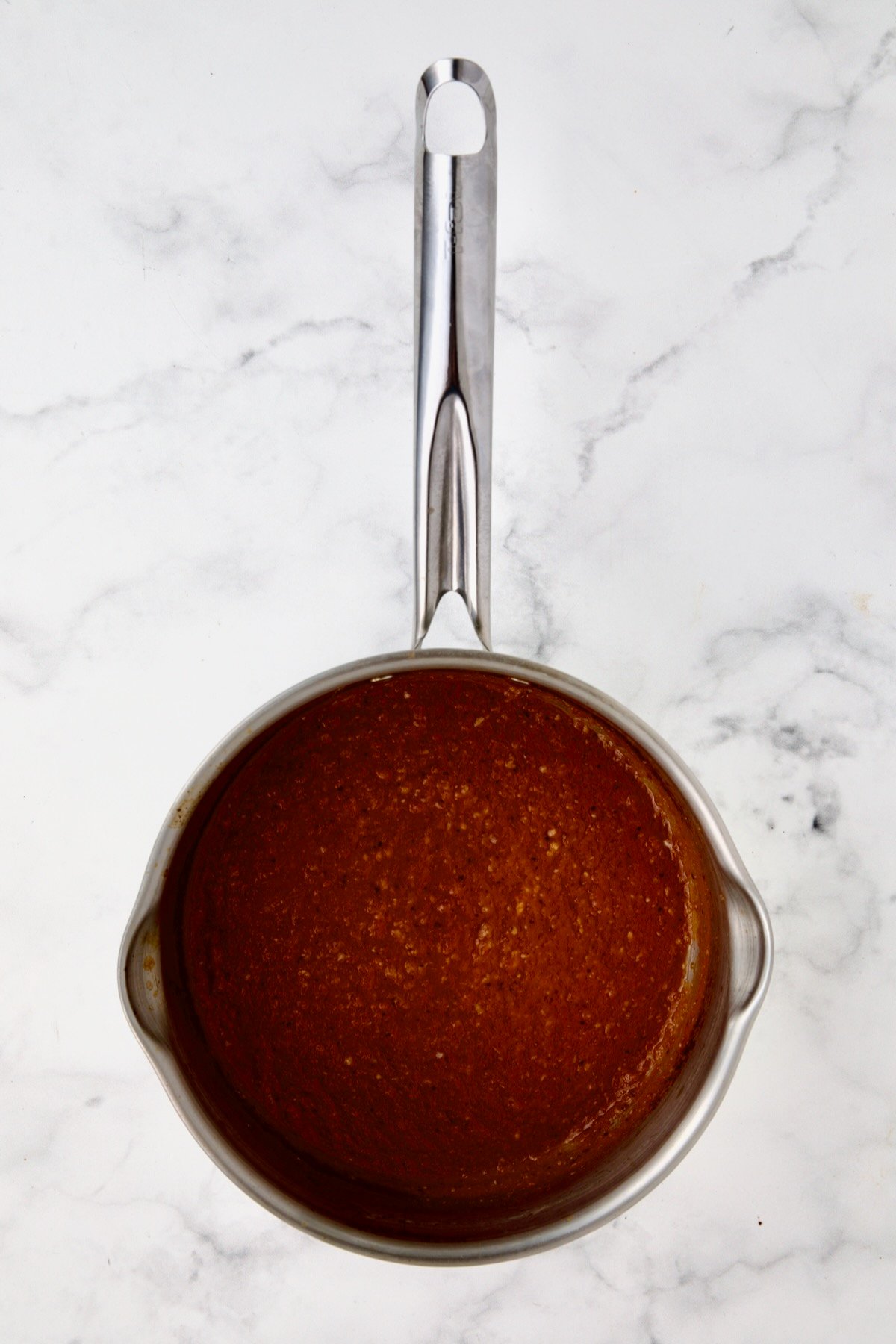Bloody Mary marinade in stainless steel saucepan after being boiled.