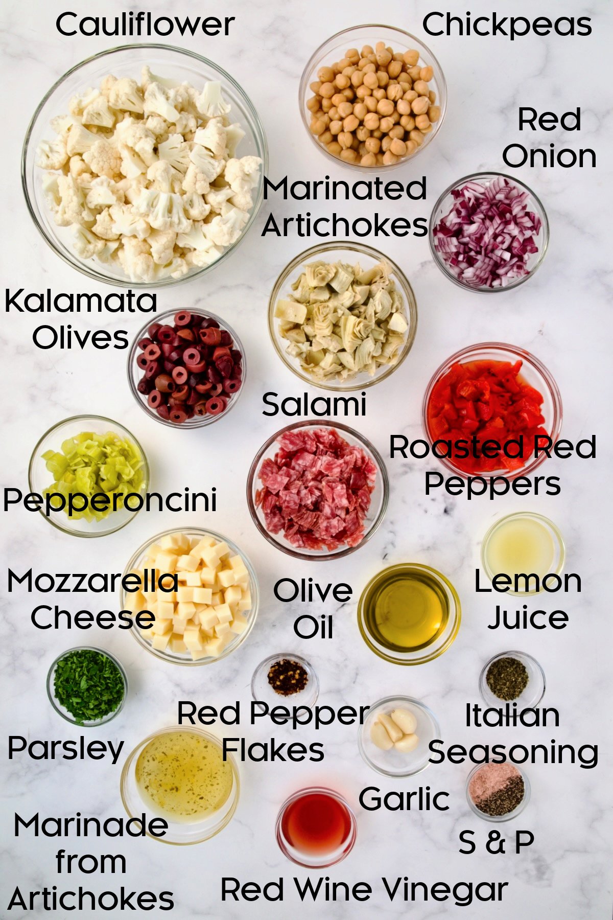 Ingredients for Cauliflower Antipasto Salad in glass bowls.