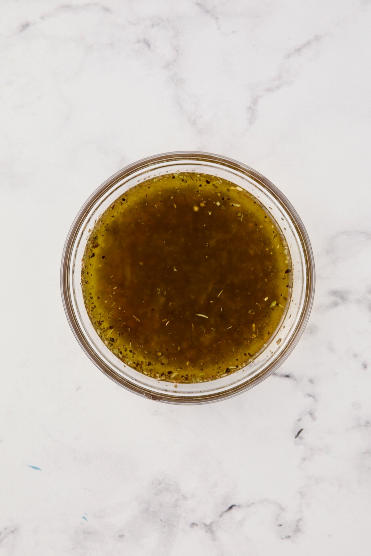 Salad dressing in glass bowl.