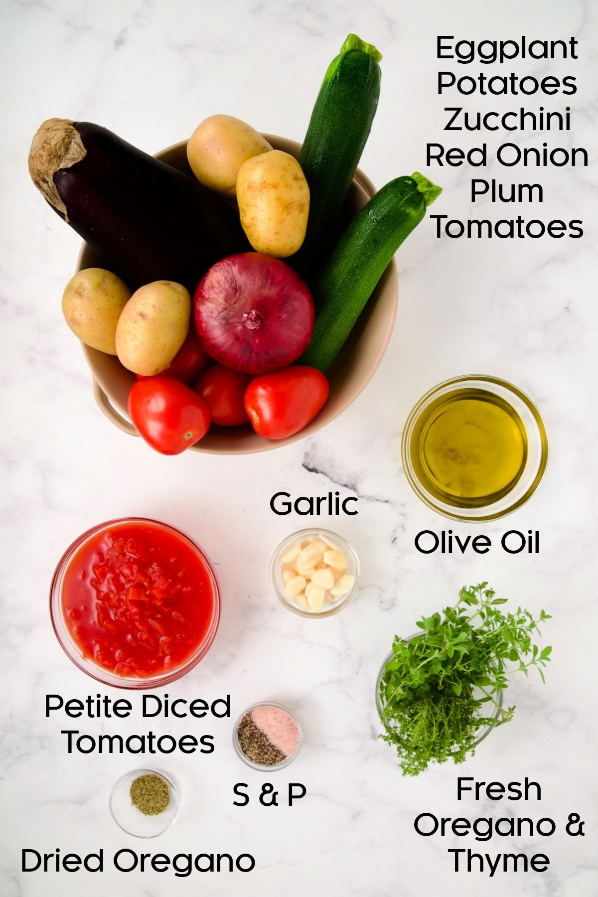 Ingredients for Briam (Greek Roast Vegetables) with the vegetables in colander and remaining ingredients in glass bowls.