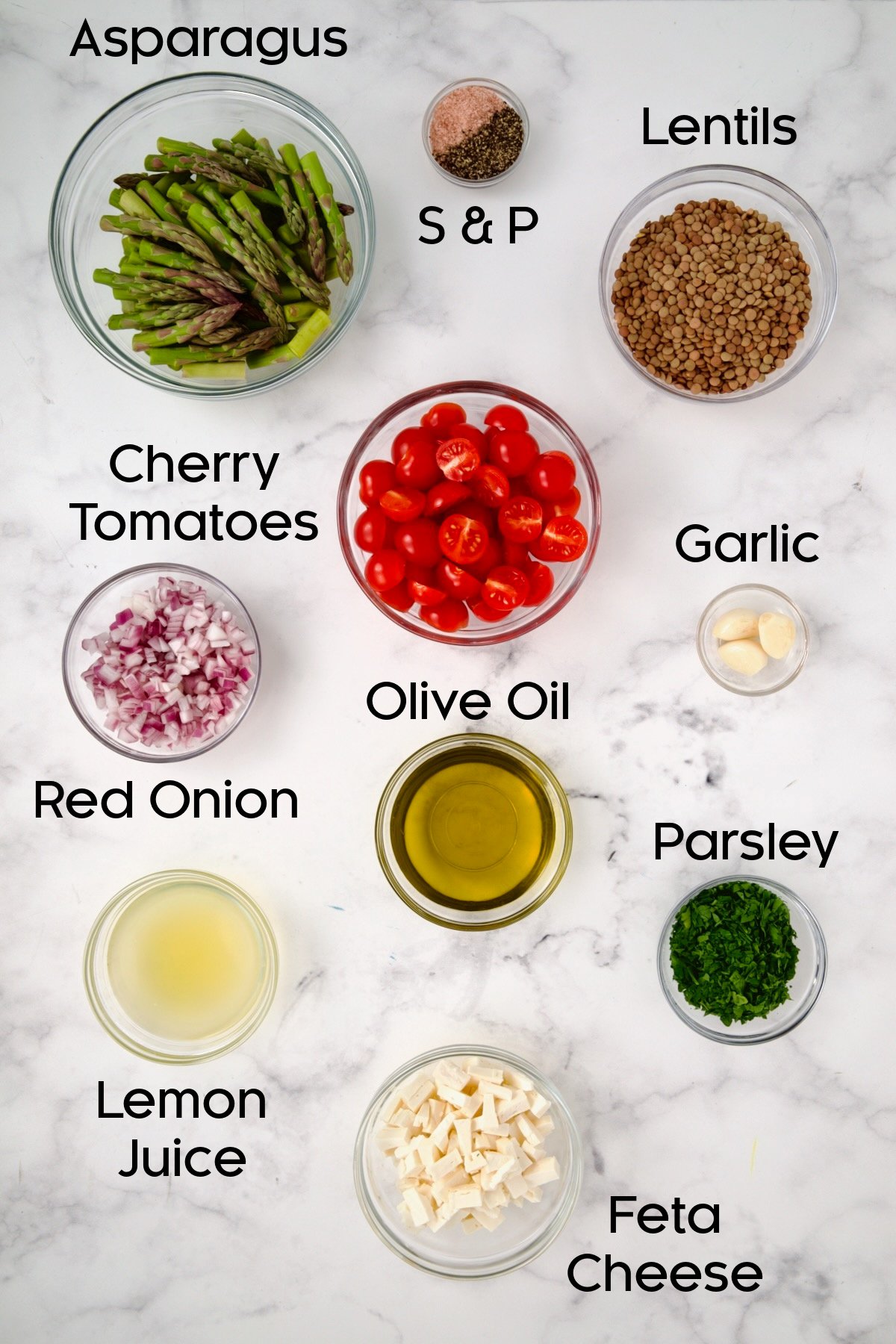 Ingredients for Lemony Lentil Salad with Asparagus and Tomatoes in glass bowls.
