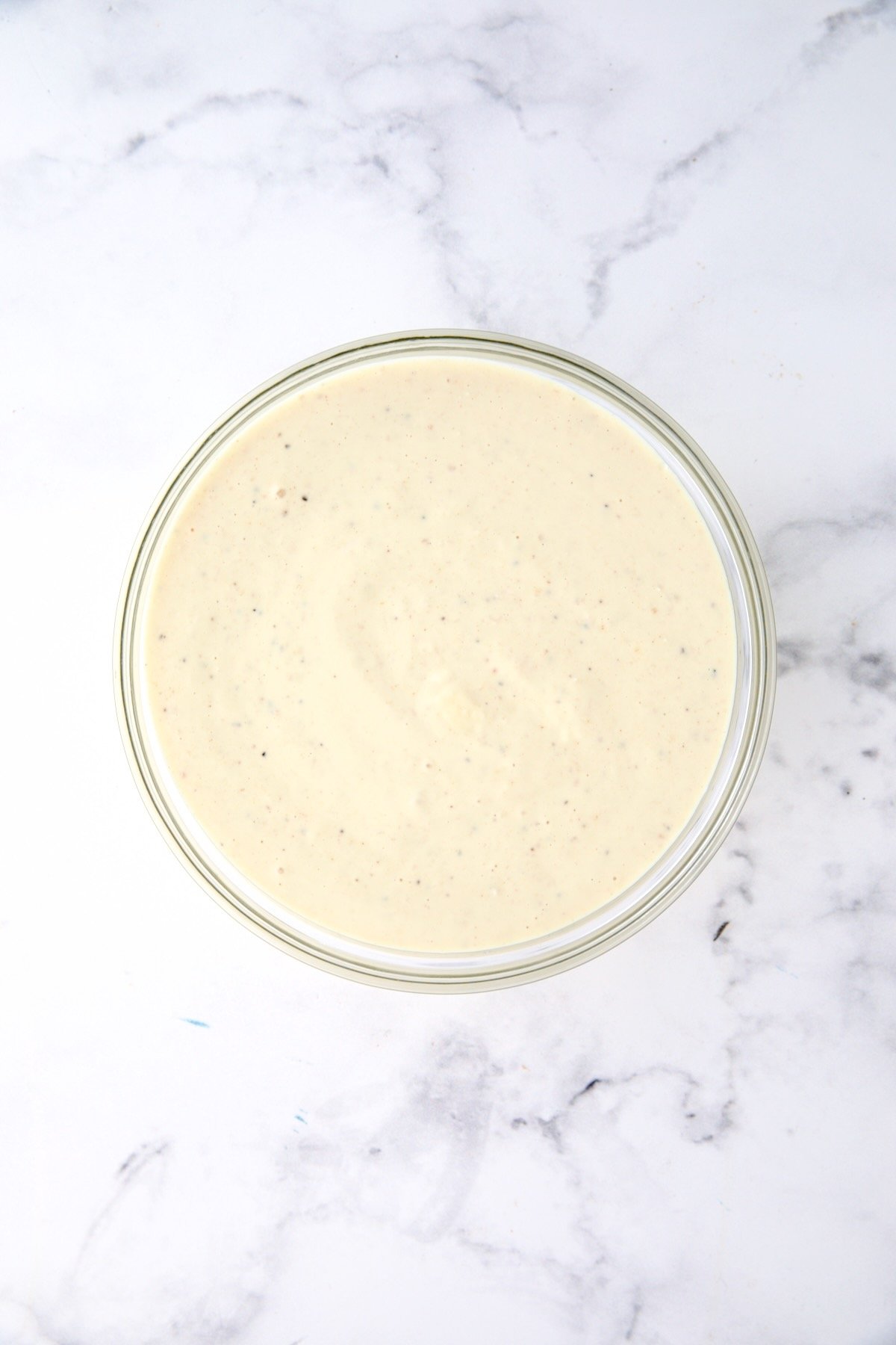 Dressing for potato salad in glass bowl.