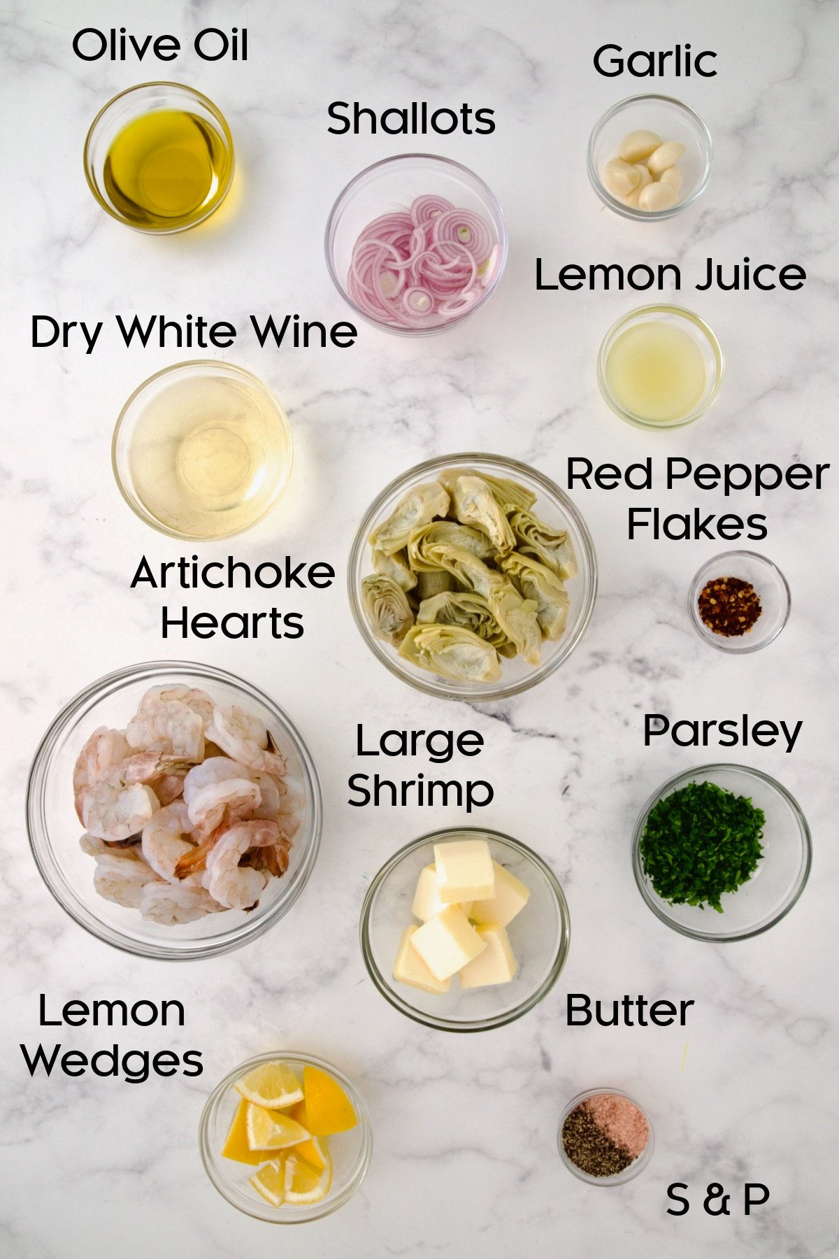 Ingredients for Shrimp Scampi with Artichokes in glass bowls.