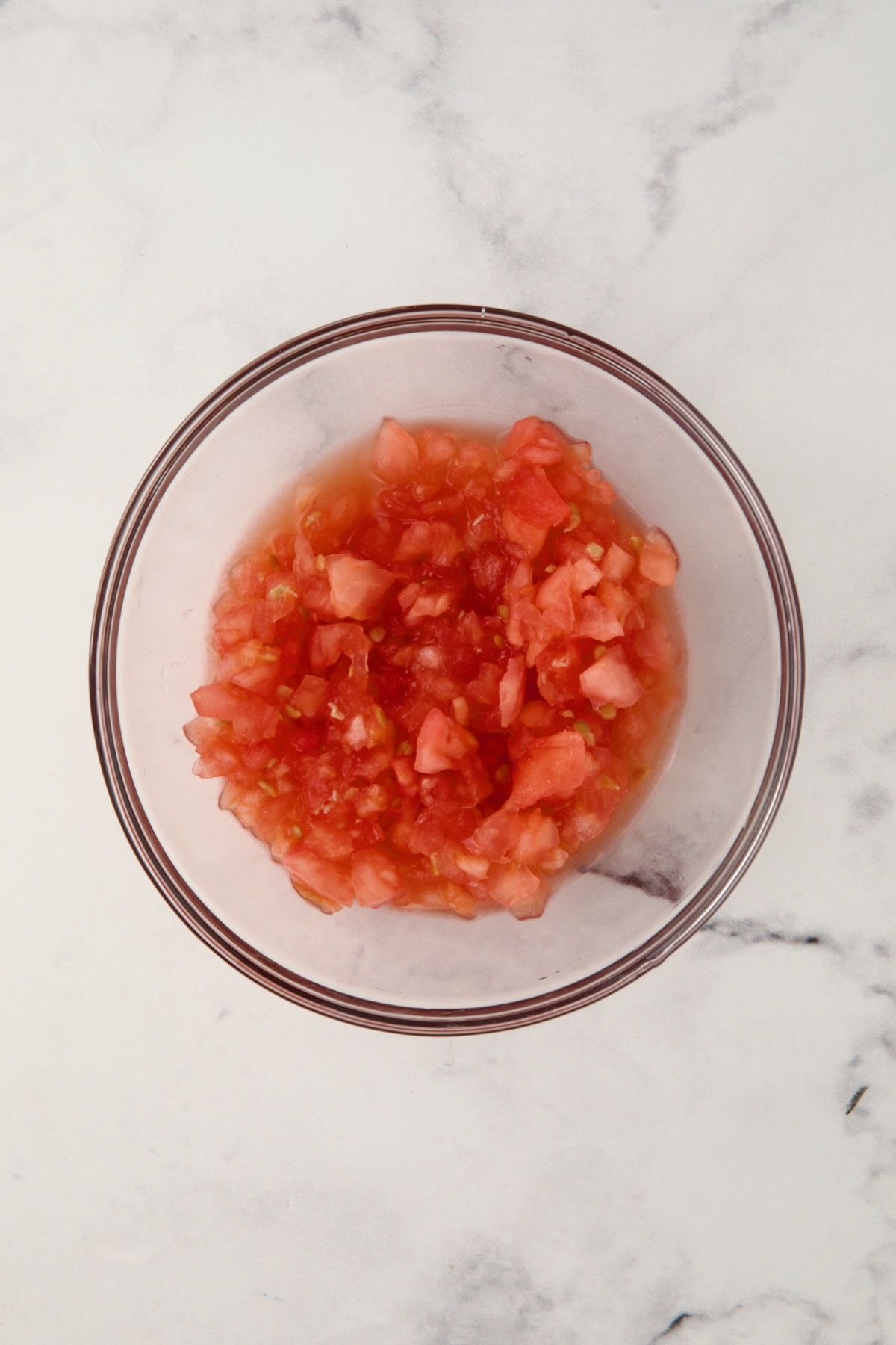 Cleaned up tomato pulp in glass bowl.