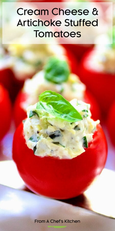 Pinterest graphic for Cream Cheese and Artichoke Stuffed Tomatoes showing one on a silver server garnished with small fresh basil leaves.